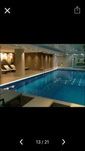 a large blue swimming pool in a building at Orbi palace room 210 in Bakuriani