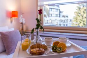 een dienblad met ontbijtproducten en drankjes op een tafel bij Apartments Mozaik in Kopaonik