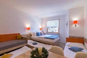 a living room with a bed and a couch at Apartments Mozaik in Kopaonik