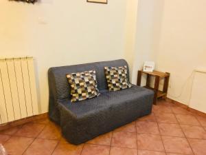 kanapę z dwoma poduszkami w pokoju w obiekcie A Due Passi Dall'Accademia we Florencji