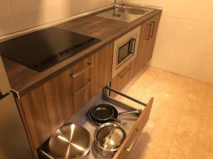 Kuchyň nebo kuchyňský kout v ubytování Apartamentos Augusto