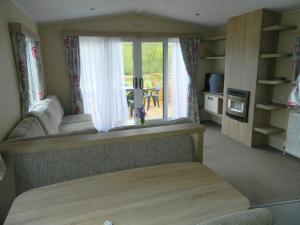 a room with a bed and a window with a table at Parkgate Farm in Holmrook