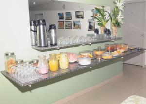 a counter with glasses and drinks on it at Hotel Pousada Universitária in Teresina