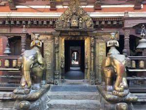 a building with two statues of elephants in it at KAJI HOME in Pātan