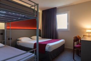 a hotel room with two bunk beds and a desk at The Originals City, Hôtel Les Bruyères, Dax Nord (Inter-Hotel) in Castets