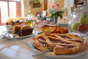 a table topped with plates filled with food at Masseria Agrituristica Lama San Giorgio in Rutigliano