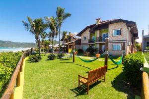 a park with a hammock in front of a house at Morada Baden Baden in Bombinhas