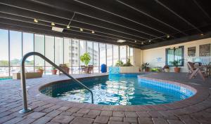 a swimming pool with a water slide in a building at Sands Beach Club Resort in Myrtle Beach