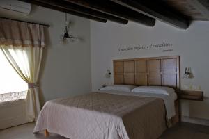 a bedroom with a bed and a window at ChocoHouse in Ragusa