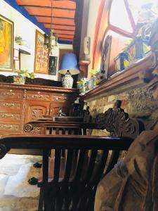 a room with a wooden bench and a dresser at Casa Azul in Guanajuato