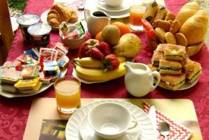 una mesa con un desayuno de sándwiches, fruta y zumo en Cerasola Bed & Breakfast, en Campello sul Clitunno