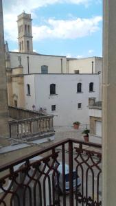 a view from a balcony of a building with a clock tower at residence specchia in Specchia +7 photos