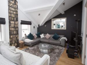 a living room with a couch and a table at Regent Penthouse in Harrogate