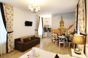 a living room with a couch and a dining room at Arhivelor Apartment in Sibiu