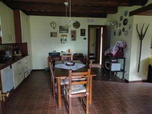 a kitchen with a table and chairs in a room at Villa Arzilla in Amandola