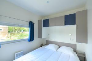 a bedroom with a white bed and a window at TI WAR AN DOUR in Guégon
