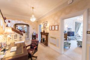 a home office with a desk and a chair at Grovefield Manor in Poole