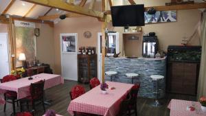a restaurant with tables and chairs and a tv on the wall at Villa Lola & Nikola in Pirot