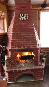 a brick oven with a fire inside of it at Villa Lola & Nikola in Pirot