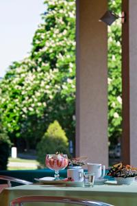 a table with cups and a bowl of food on it at Termálhotel Martfű in Martfů