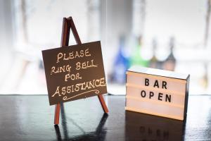 a chalkboard and a bar open sign on a table at Grovefield Manor in Poole