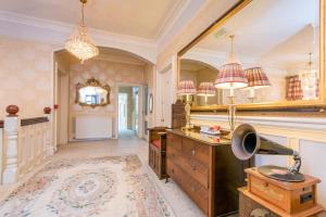 a bathroom with a dresser and a mirror at Grovefield Manor in Poole