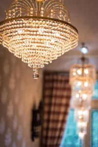 a chandelier hanging from a ceiling in a room at Grovefield Manor in Poole