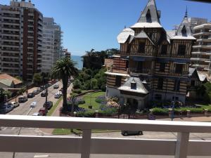 a building with a house on the side of a street at Hotel Imperio in Mar del Plata