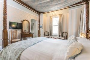 a bedroom with a large bed and a desk at Grovefield Manor in Poole