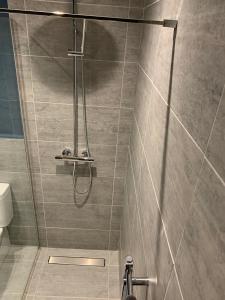 a shower with a glass door in a bathroom at The Tower Arms Hotel in Iver