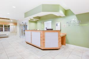 a lobby of a hospital with a reception counter at Microtel Inn & Suites by Wyndham Saraland in Saraland