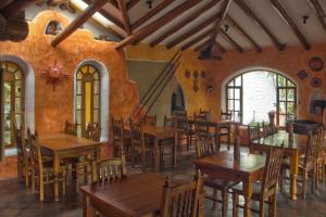 a dining room with wooden tables and chairs at INTIYAYA - Boutique Lodge in Otavalo