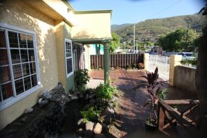 a house with a brick walkway next to a building at Swimaz Gateway in Harbour View