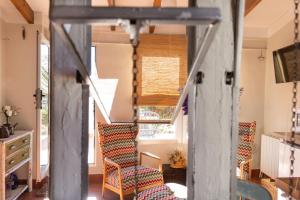 a room with a staircase with chairs and a table at Casa Rosalía in Ibi