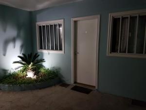 a room with a door and a plant in front of it at Apartamento Cabo Frio in Cabo Frio