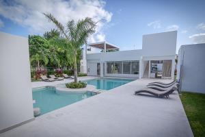a villa with a swimming pool and a house at Casa Pakal in Puerto Morelos