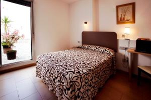 Postel nebo postele na pokoji v ubytování Hostal San Marcos