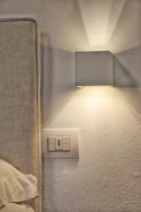 a white wall with a white light on top of it at Hotel Tiffany in Marina di Massa