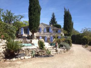 a house with a swimming pool and trees at La Bergerie in Saint-Jeannet