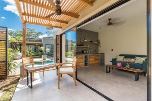 a kitchen and living room with a table and chairs at Zen Garden Tamarindo - Adults Only in Tamarindo