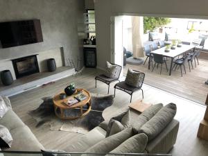 a living room with a couch and a table at 7 The Dunes, Sanctuary Beach in Plettenberg Bay