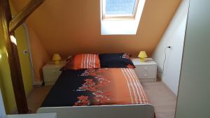 a small bedroom with a bed and a window at Apartma Pr Maruši in Bovec