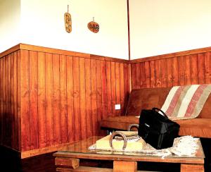 a room with a couch and a table with a book at Dorotea Vista in Puerto Natales