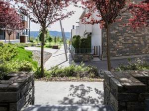 a garden with trees and a stone wall at ESQUI - PIRINEO DE HUESCA - GOLF & RELAX - VALLE de TENA in Sabiñánigo