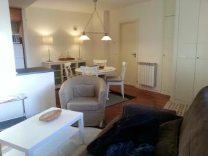 a living room with a couch and a table at ESQUI - PIRINEO DE HUESCA - GOLF & RELAX - VALLE de TENA in Sabiñánigo