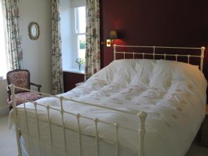 A bed or beds in a room at High Rigg B&B 