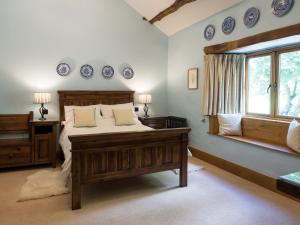 a bedroom with a bed and blue plates on the wall at The Wayside and Whisky Barn in Whitbeck