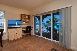 a living room with a desk and a window at Bridgewalk, a Landmark Resort in Bradenton Beach