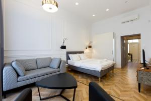a living room with a couch and a bed at The Oktogon Executive Apartment in Budapest
