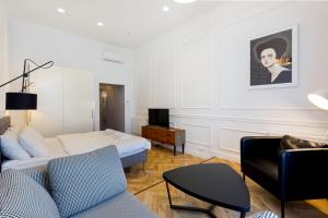 a living room with a bed and a couch at The Oktogon Executive Apartment in Budapest